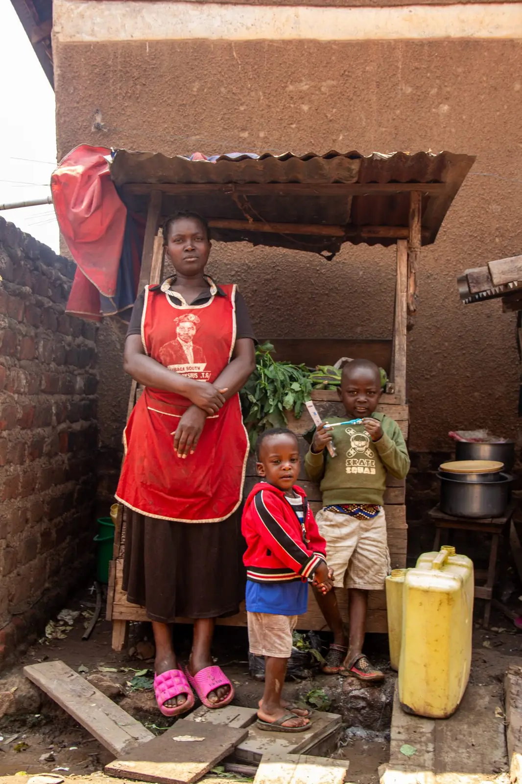 Mother and children in front of a community market stall