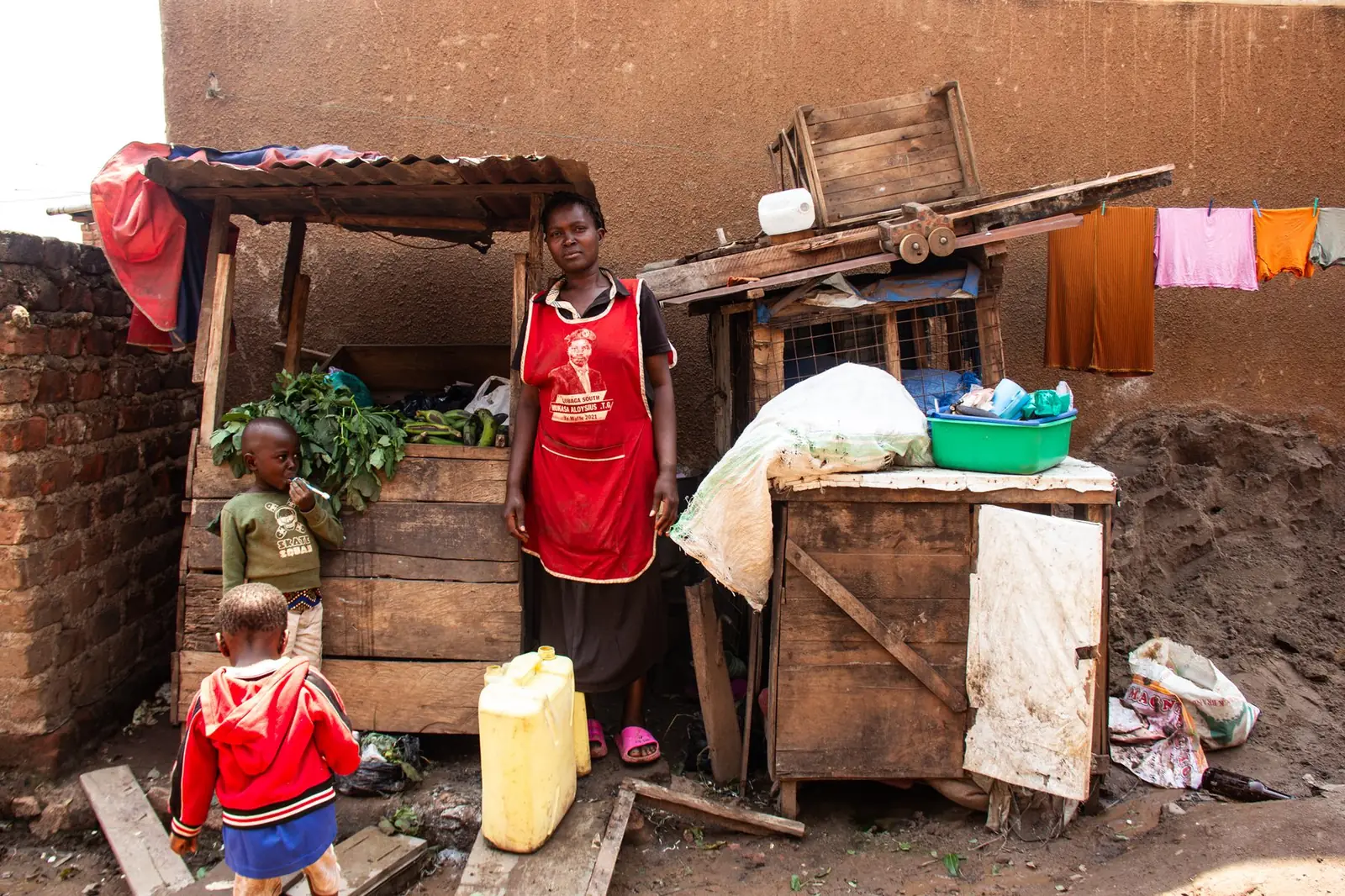 Woman and children near community market stalls
