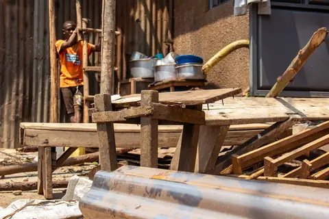 Young person in a community workshop yard