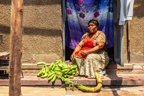 Community member outside her home and workplace