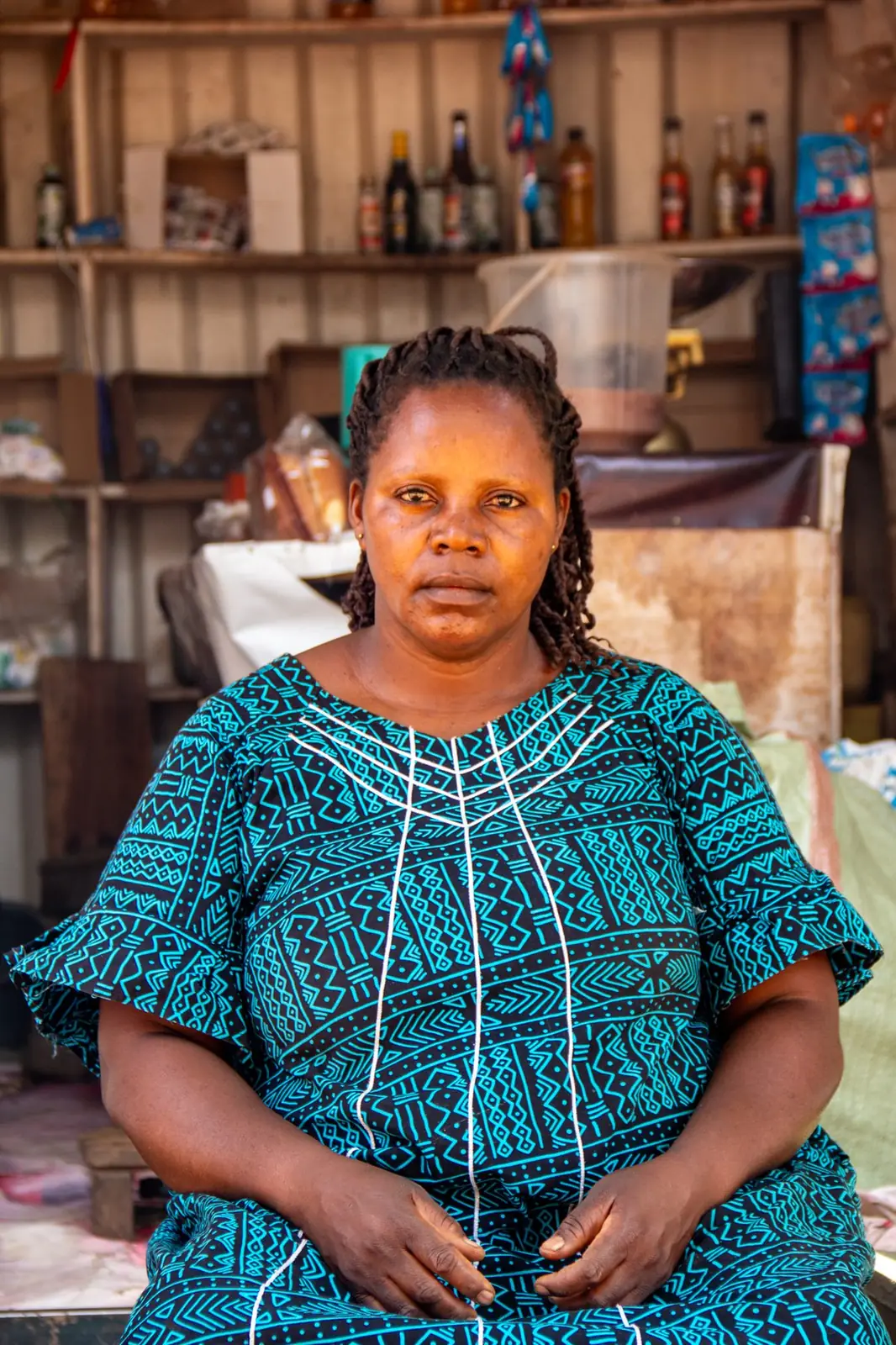Woman entrepreneur seated in her community shop