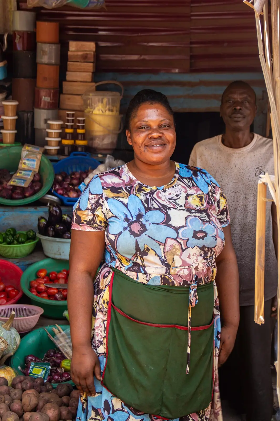 Woman entrepreneur smiling at her market stall in the community