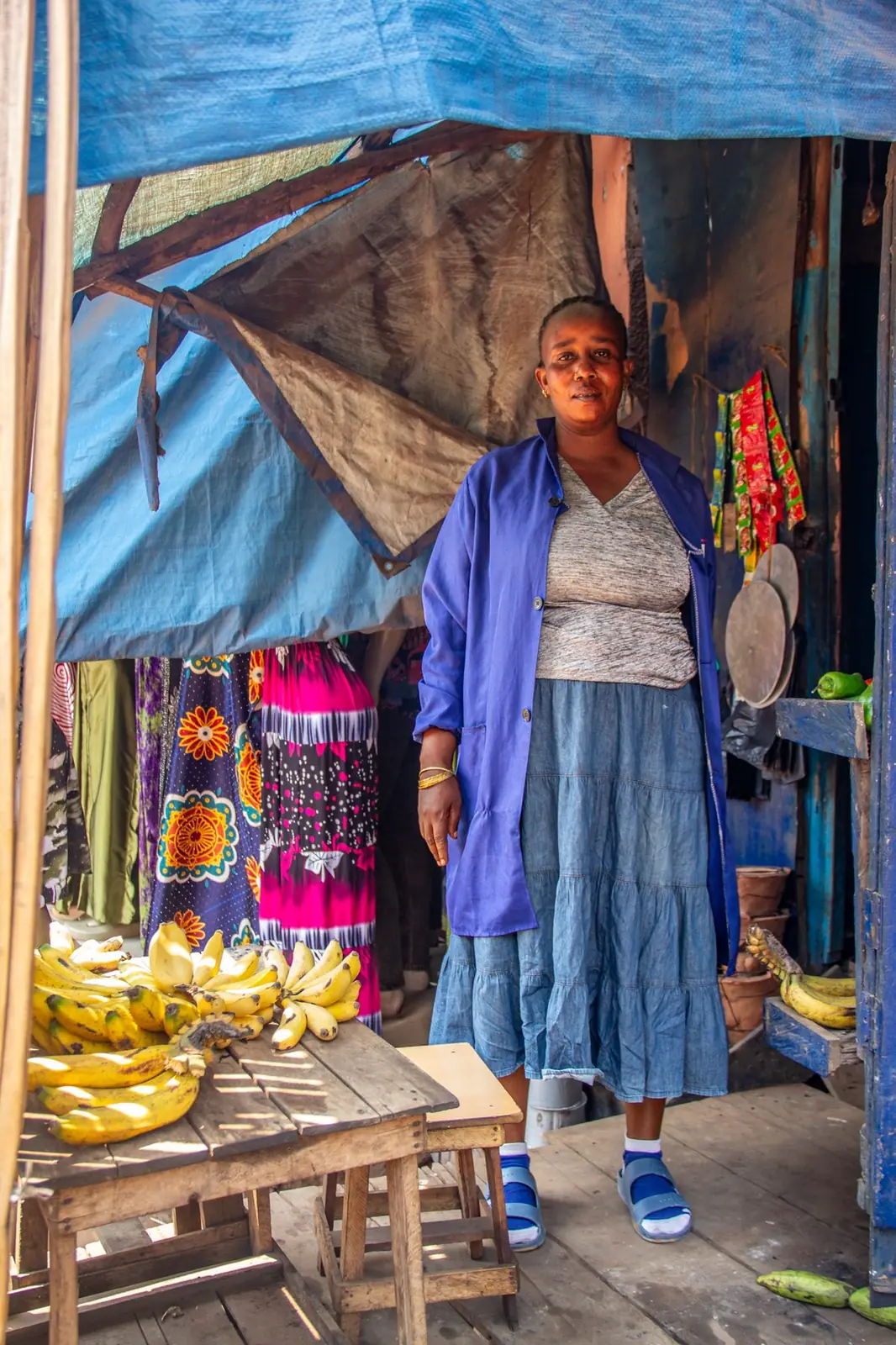Woman entrepreneur at her banana and goods stall